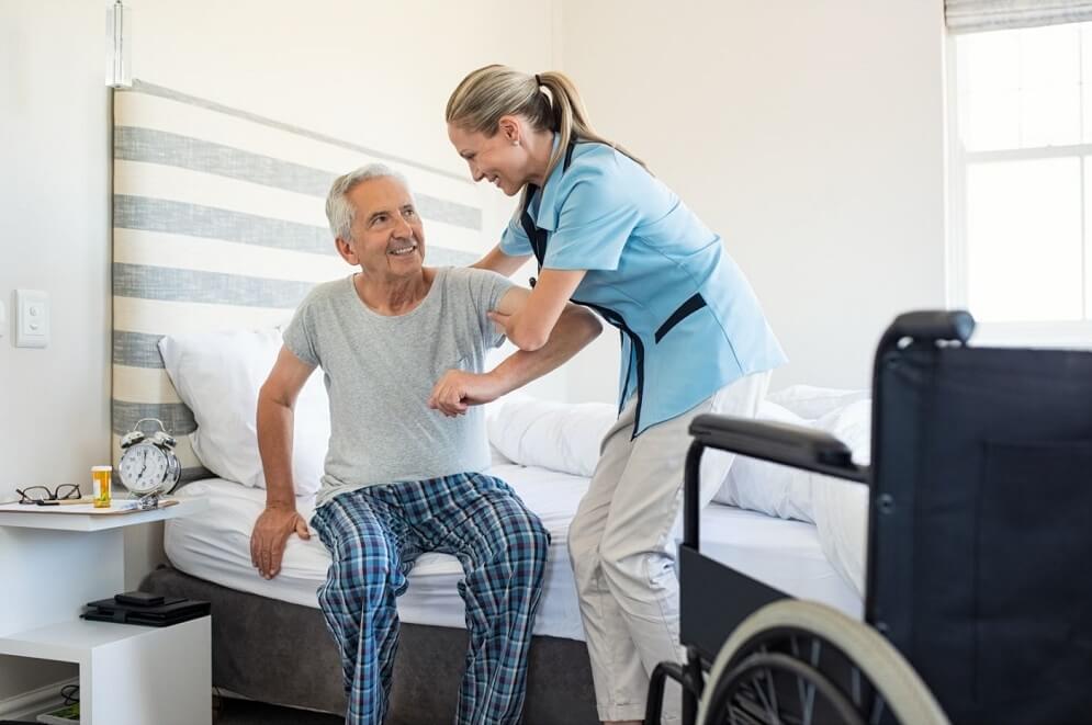 CNA Helping Old Patient Get up